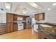 Kitchen features wood cabinets, stainless steel appliances, recessed lights and light wood flooring at 12371 Talpa St, Spring Hill, FL 34608