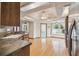 Eat-in kitchen features wood floors, stainless steel appliances, wood cabinets, and light fixtures at 12371 Talpa St, Spring Hill, FL 34608
