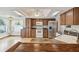 Kitchen features stainless steel appliances, stone tile counter and view to breakfast nook at 12371 Talpa St, Spring Hill, FL 34608