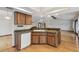Kitchen features wood cabinets, stone tile counter and flows into the open-concept living space at 12371 Talpa St, Spring Hill, FL 34608