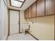 Laundry room featuring a utility sink and wood cabinets at 12371 Talpa St, Spring Hill, FL 34608