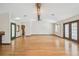Bright living room features hardwood floors and neutral paint, with multiple doorways at 12371 Talpa St, Spring Hill, FL 34608