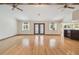 Open living room with hardwood floors, ceiling fans, and natural light at 12371 Talpa St, Spring Hill, FL 34608