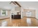 Open concept living space with kitchen access, hardwood floors, and neutral paint at 12371 Talpa St, Spring Hill, FL 34608