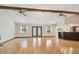 Bright living room with vaulted ceilings, hardwood floors, ceiling fans, and bar access to the kitchen at 12371 Talpa St, Spring Hill, FL 34608