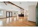 Spacious living room with beautiful hardwood floors, ceiling fans, and natural lighting at 12371 Talpa St, Spring Hill, FL 34608