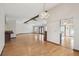 Open-concept living room features hard wood floors, chandelier, and ceiling fans at 12371 Talpa St, Spring Hill, FL 34608