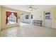 Bright sunroom with tile floors, white door, and window overlooking the screened-in pool at 12371 Talpa St, Spring Hill, FL 34608