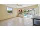 Bright sunroom featuring tile floors, neutral tones and sliding glass doors opening to an outdoor swimming pool at 12371 Talpa St, Spring Hill, FL 34608