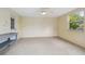 Neutral sunroom featuring neutral walls, tile flooring, windows and a door to the backyard at 12371 Talpa St, Spring Hill, FL 34608