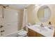 Bathroom featuring a bathtub with shower, a round mirror, and a white sink and toilet at 143 Lakeside Dr # 143, Oldsmar, FL 34677
