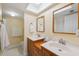 Bright bathroom featuring a double sink vanity with wood cabinets and a large mirror at 143 Lakeside Dr # 143, Oldsmar, FL 34677