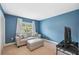 Cozy bedroom showcasing blue walls, comfortable seating, and ample natural light at 143 Lakeside Dr # 143, Oldsmar, FL 34677
