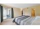 Bright bedroom with sliding glass doors to patio, and adjacent bathroom at 143 Lakeside Dr # 143, Oldsmar, FL 34677