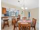 Inviting dining area with chandelier and counter seating, perfect for entertaining at 143 Lakeside Dr # 143, Oldsmar, FL 34677
