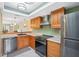 Well-equipped kitchen featuring stainless steel appliances, ample counter space, and modern lighting at 143 Lakeside Dr # 143, Oldsmar, FL 34677