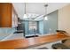 Compact kitchen bar with stylish pendant lights, complemented by modern backsplash and fixtures at 143 Lakeside Dr # 143, Oldsmar, FL 34677