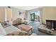 Inviting living room with a fireplace and sliding doors to a screened in patio at 143 Lakeside Dr # 143, Oldsmar, FL 34677
