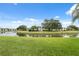 Scenic view of the building complex overlooking a tranquil pond with lush green landscaping at 143 Lakeside Dr # 143, Oldsmar, FL 34677