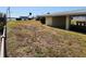 Spacious backyard with a covered boat lift, providing easy access to the water and parking for your watercraft at 1447 Lemon Bay Dr, Englewood, FL 34223