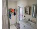 Bathroom vanity with modern sink, cabinet, decorated mirror, and unique wall accents at 1447 Lemon Bay Dr, Englewood, FL 34223