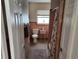 Cozy peach bathroom with a white toilet, shower with seashell curtain, window, and tiled floor at 1447 Lemon Bay Dr, Englewood, FL 34223