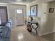 Bright entryway featuring tiled flooring, a glass-topped console table, and a decorative nautical-themed art piece at 1447 Lemon Bay Dr, Englewood, FL 34223