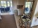 Inviting entryway with a glass table and a decorative mirror, leading to a sunroom with stylish blue wicker furniture at 1447 Lemon Bay Dr, Englewood, FL 34223
