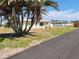 Charming single-story home with a well-maintained lawn and mature palm trees at 1447 Lemon Bay Dr, Englewood, FL 34223