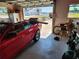 Garage interior with a red convertible and a view of the waterfront across the street at 1447 Lemon Bay Dr, Englewood, FL 34223