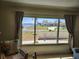 Living room view showcasing a large window with a scenic view of the water and neighboring homes at 1447 Lemon Bay Dr, Englewood, FL 34223