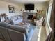 Cozy living room featuring a stone fireplace, comfortable seating, and a large TV for entertainment at 1447 Lemon Bay Dr, Englewood, FL 34223