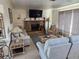 Inviting living room with stone fireplace, sofas, coastal decor, and large window, perfect for relaxing and entertaining at 1447 Lemon Bay Dr, Englewood, FL 34223