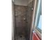 Shower featuring tiled walls, a glass door, and updated fixtures at 1447 Lemon Bay Dr, Englewood, FL 34223