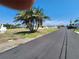Street view of the cottages, with palm trees, and a clear blue sky at 1447 Lemon Bay Dr, Englewood, FL 34223