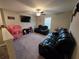 Cozy upstairs living room featuring comfortable seating, a ceiling fan, and a bright window at 1561 Flower Dust Dr, Ruskin, FL 33570