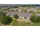 An aerial view of the property highlights the backyard and community featuring a pond and well-maintained landscaping at 1713 Trailwater St, Ruskin, FL 33570