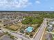An aerial view shows the community pool, playground and surrounding homes with lush greenery in the neighborhood at 1713 Trailwater St, Ruskin, FL 33570
