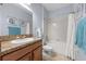 Well-lit bathroom with granite countertops, neutral tones, and shower-tub combo at 1713 Trailwater St, Ruskin, FL 33570