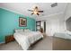 Bright bedroom with a modern ceiling fan, neutral tones, and a sliding barn door at 1713 Trailwater St, Ruskin, FL 33570