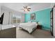 Bright bedroom with a modern ceiling fan, neutral tones, and a sliding barn door at 1713 Trailwater St, Ruskin, FL 33570