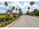 The Hawks Point community entrance features lush landscaping, a gated entrance, and a welcoming sign at 1713 Trailwater St, Ruskin, FL 33570