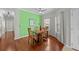 Bright dining room with hardwood floors, modern lighting fixture, and large windows at 1713 Trailwater St, Ruskin, FL 33570