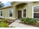 Inviting home entrance with neutral paint, manicured landscaping and decorative bushes at 1713 Trailwater St, Ruskin, FL 33570