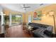 Bright and airy living room featuring hardwood floors, modern lighting, and sliding glass doors to the lanai at 1713 Trailwater St, Ruskin, FL 33570