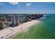 Coastal aerial showcasing a beachfront condo building with a long sandy shoreline at 17408 Gulf Blvd # 203, Redington Shores, FL 33708