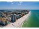 Coastal aerial showcasing a beachfront condo building with a long sandy shoreline at 17408 Gulf Blvd # 203, Redington Shores, FL 33708