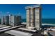 Aerial view showcasing a condo building near the beach with covered parking at 17408 Gulf Blvd # 203, Redington Shores, FL 33708