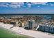 Amazing aerial view showcasing beachfront condos along a white sandy beach and turquoise ocean at 17408 Gulf Blvd # 203, Redington Shores, FL 33708