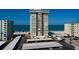 Aerial view of a beachfront condo building with covered parking and beach access at 17408 Gulf Blvd # 203, Redington Shores, FL 33708